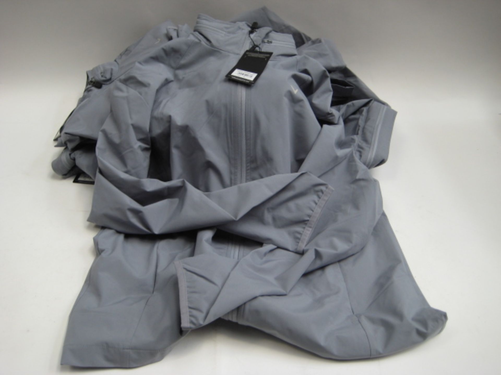 Bag containing six grey Calloway lightweight jackets, various sizes