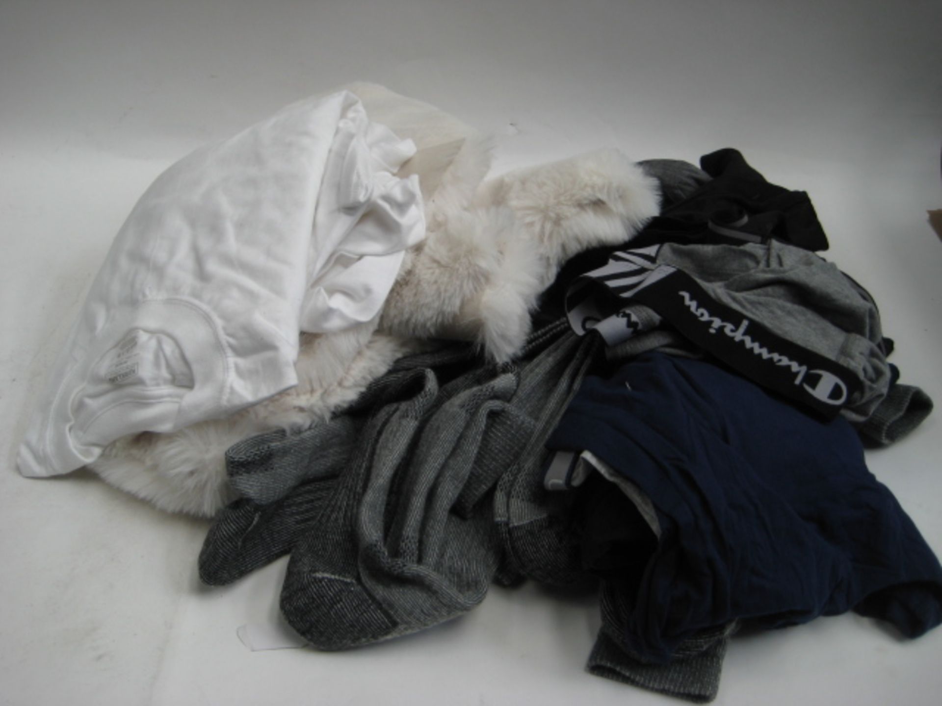 Bag containing gents socks, under pants, sthirts together with a small faux fur rug