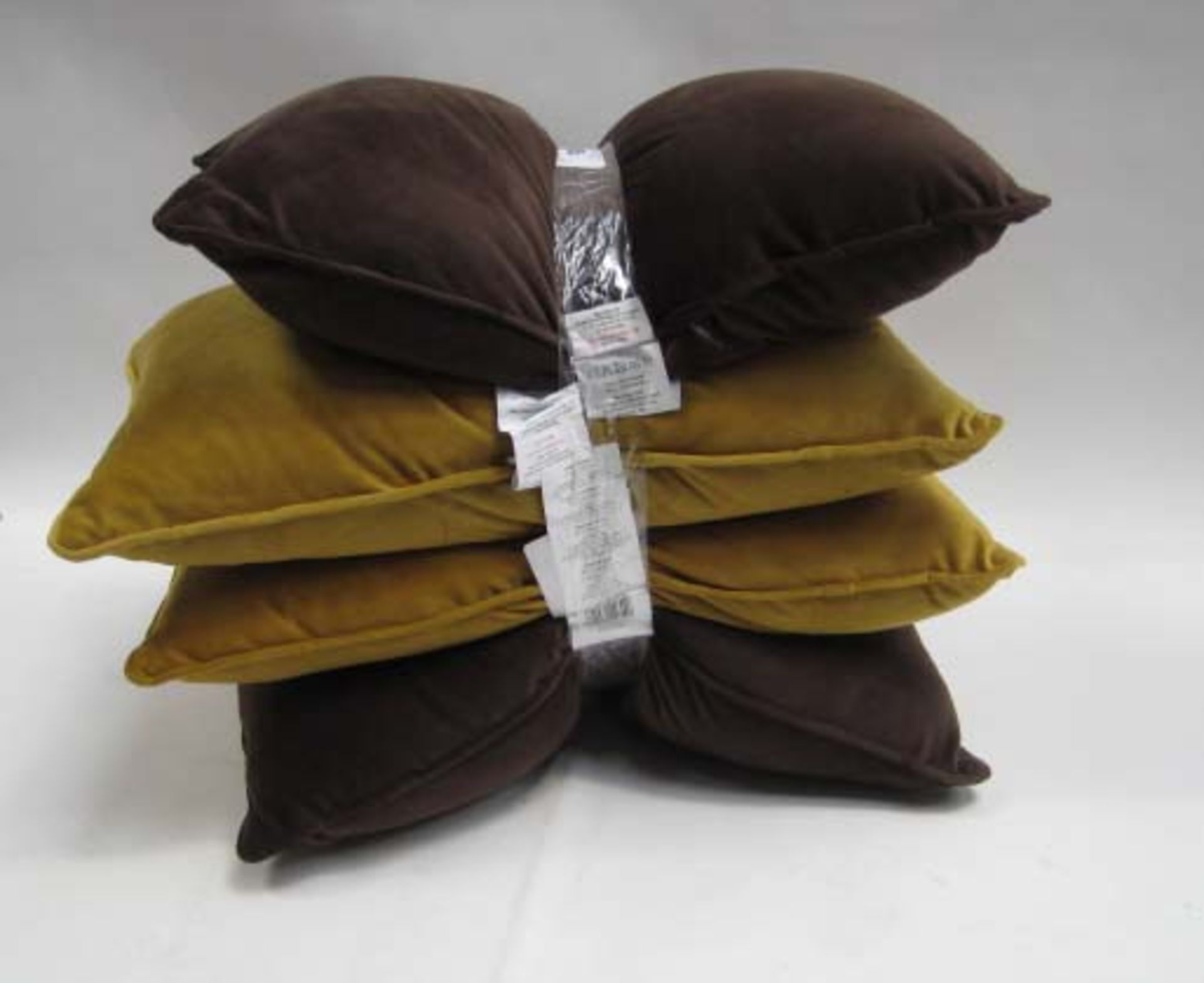 4 small rectangular pillows, 2 in dark brown and 2 in mustard colour