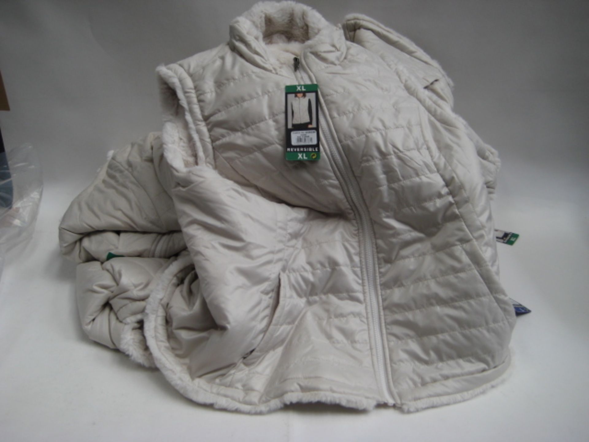 Bag containing 7 ladies reversible gilets by Nicole Miller in ivory, sizes mostly XL and one L