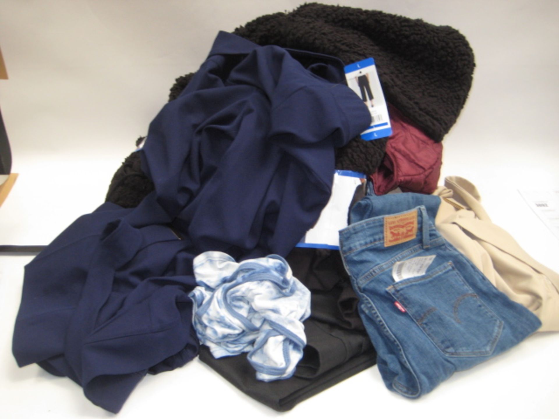 Bag containing ladies clothing to include crop trousers, fleecy zipped jackets, pair of Levi