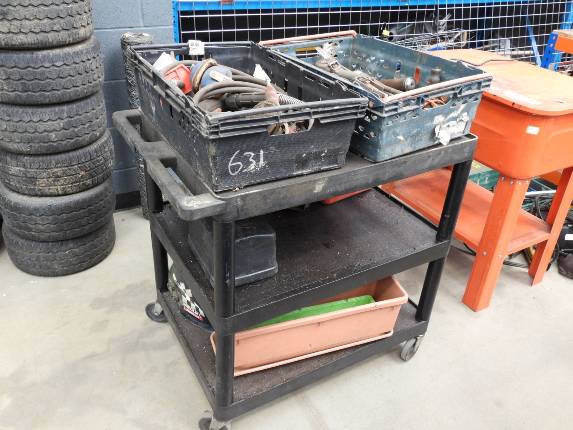 Large plastic trolley containing funnels, fuel cans, air tools, welding helmet, etc