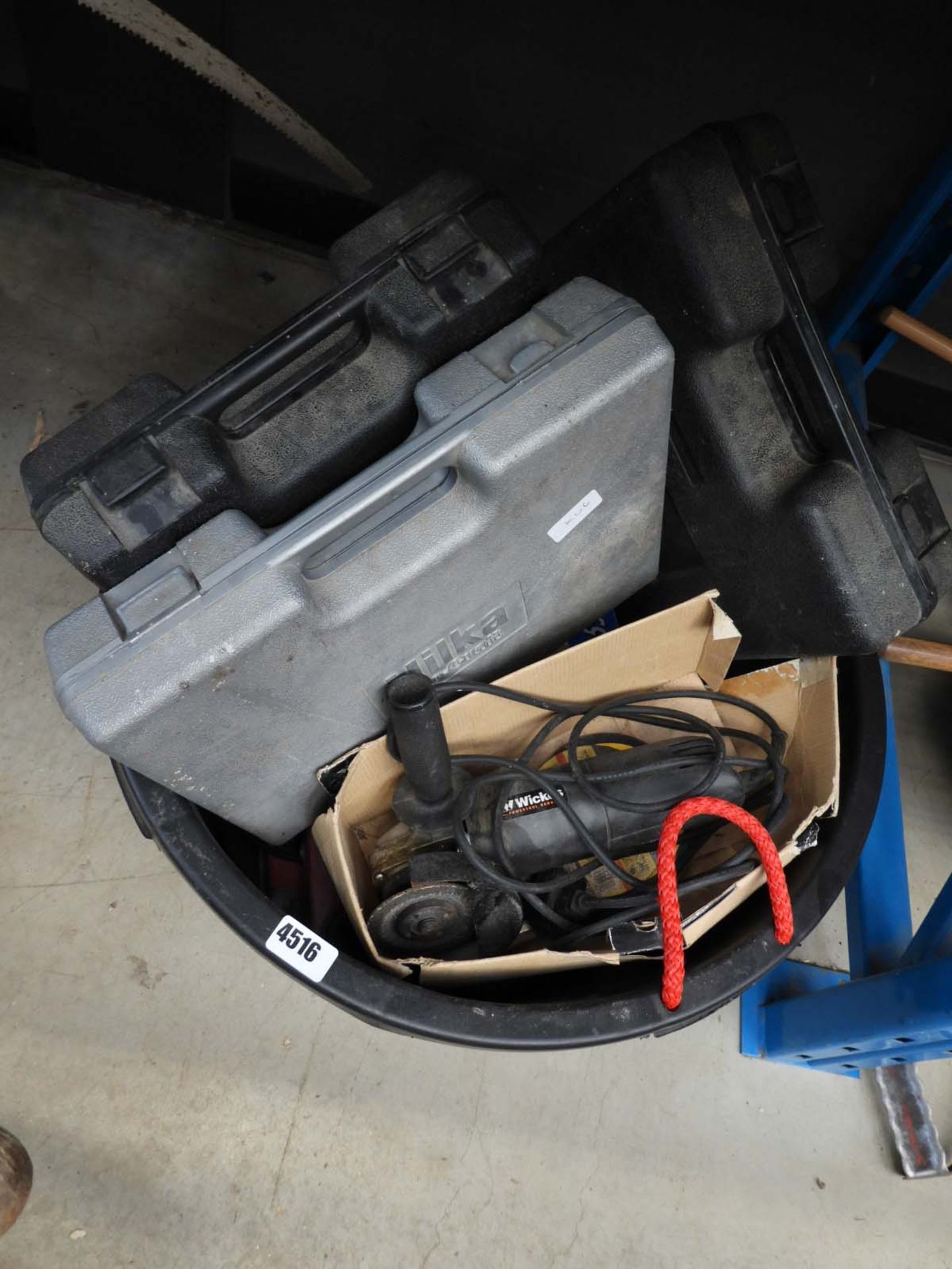 Large plastic bucket containing drills, grinders, sanders and various other electrical tools