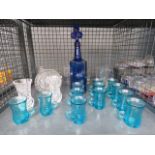 Cage containing blue glasses plus a decanter, ale mugs and a bowl