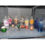 Cage containing vintage milk bottles plus medicine bottles and a cigarette case