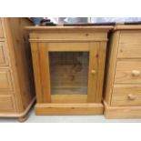 Glazed pine single door cabinet