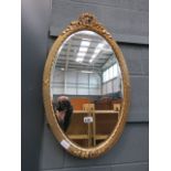 Oval bevelled mirror in gilt frame