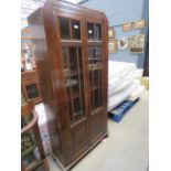 Glazed dark oak double door bookcase (damaged glass panel)