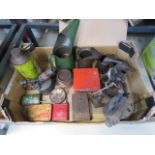 Box containing oil cans and tins