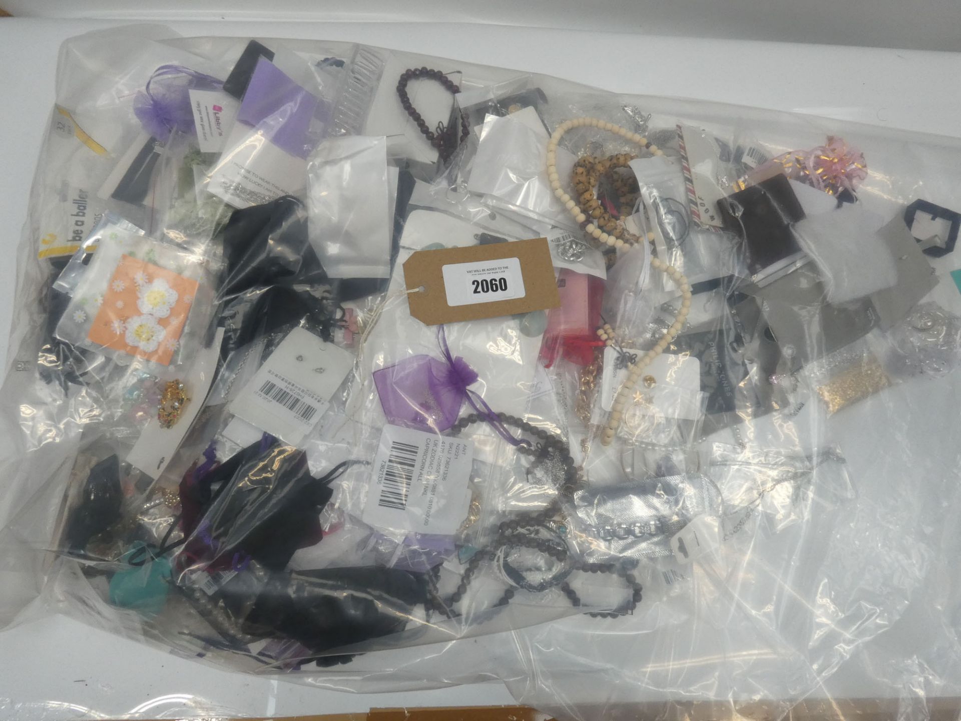 Bag containing quantity of loose costume and dress jewellery