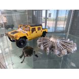 Model of a Hummer plus a metal insect and an engine part