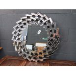 Multi-panelled circular mirror