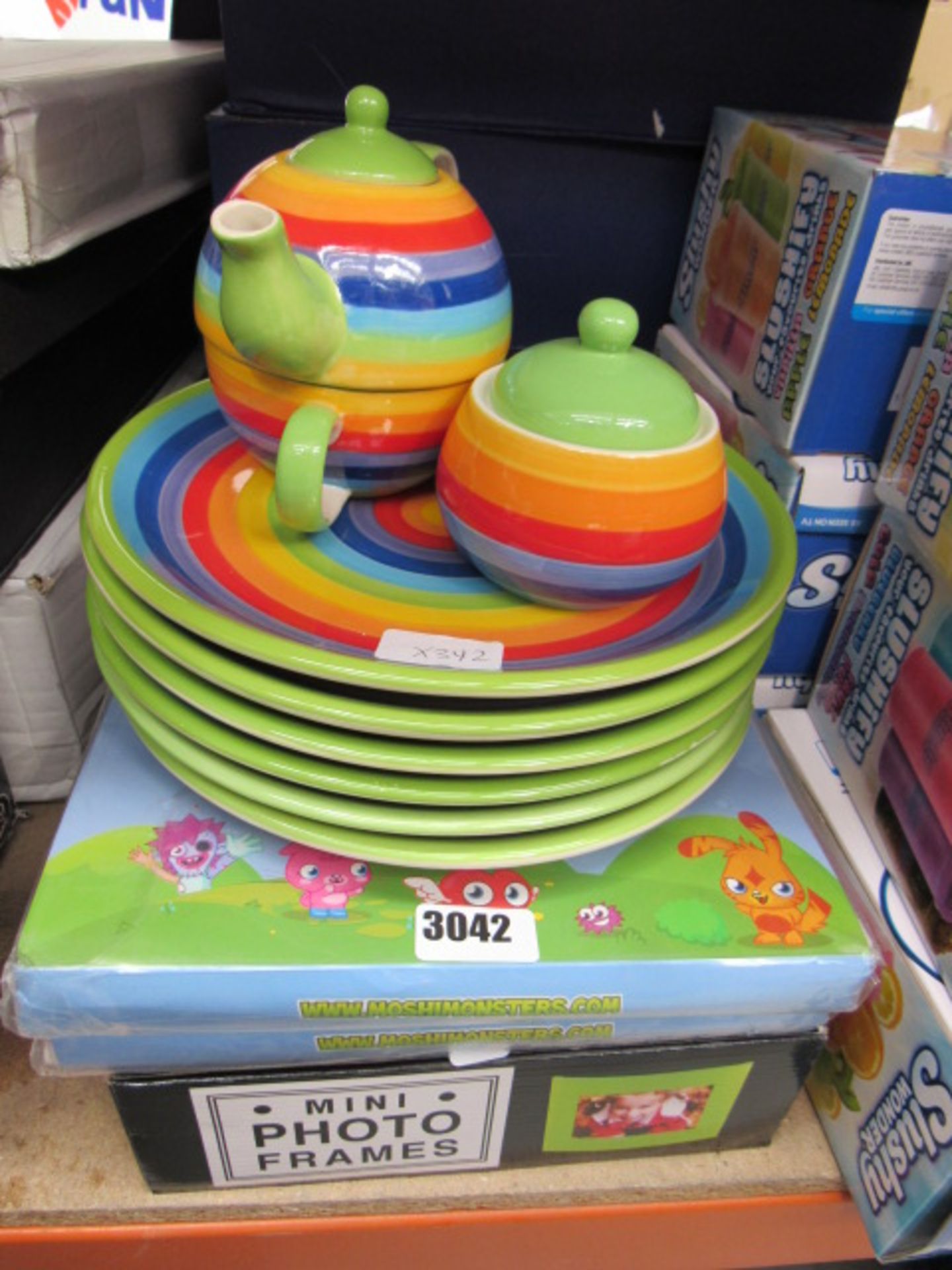 Multicoloured plates with a small teapot plus 2 Moshi Monster duvet sets and a mini photo frame