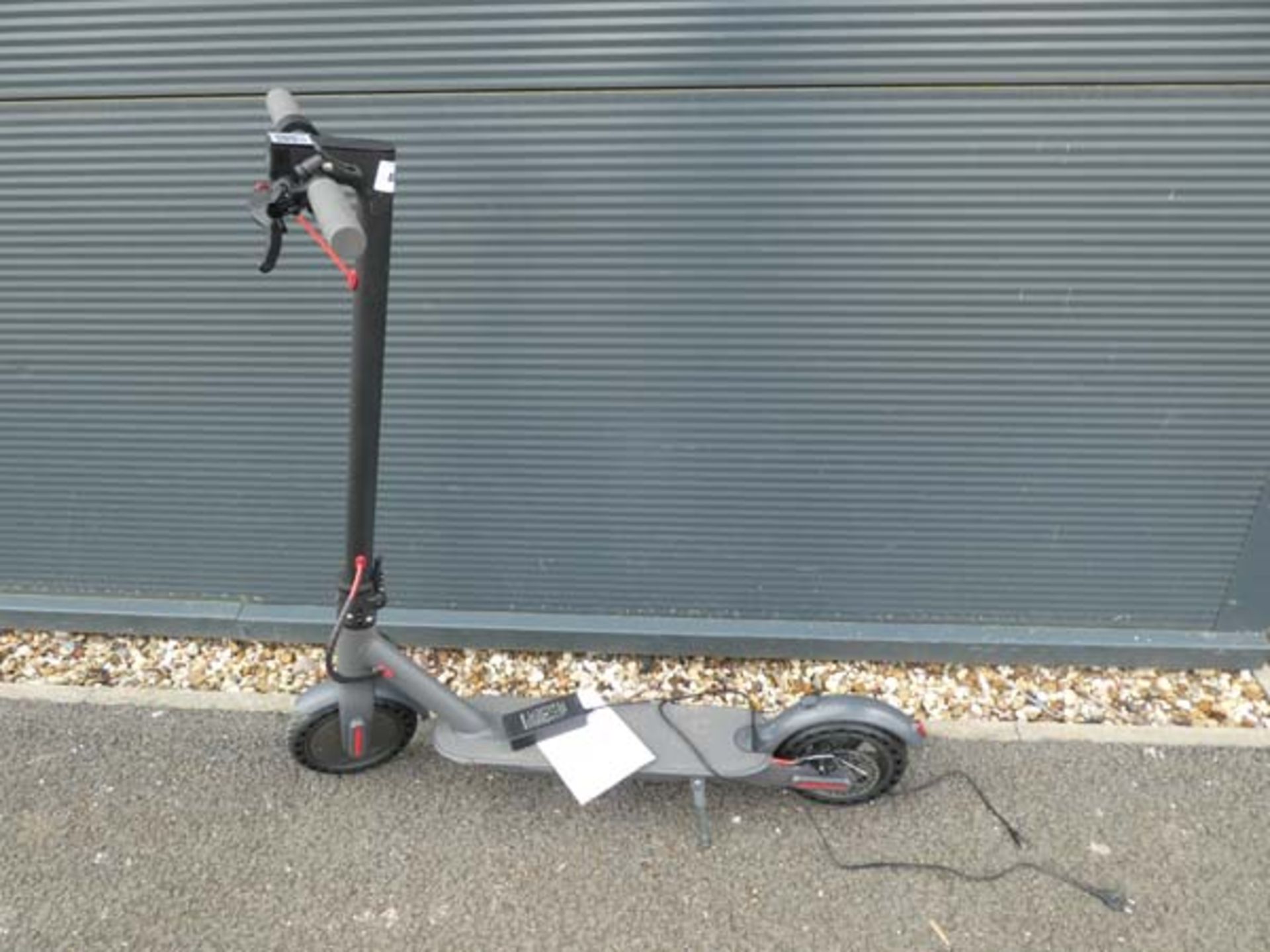 Grey electric scooter with charger