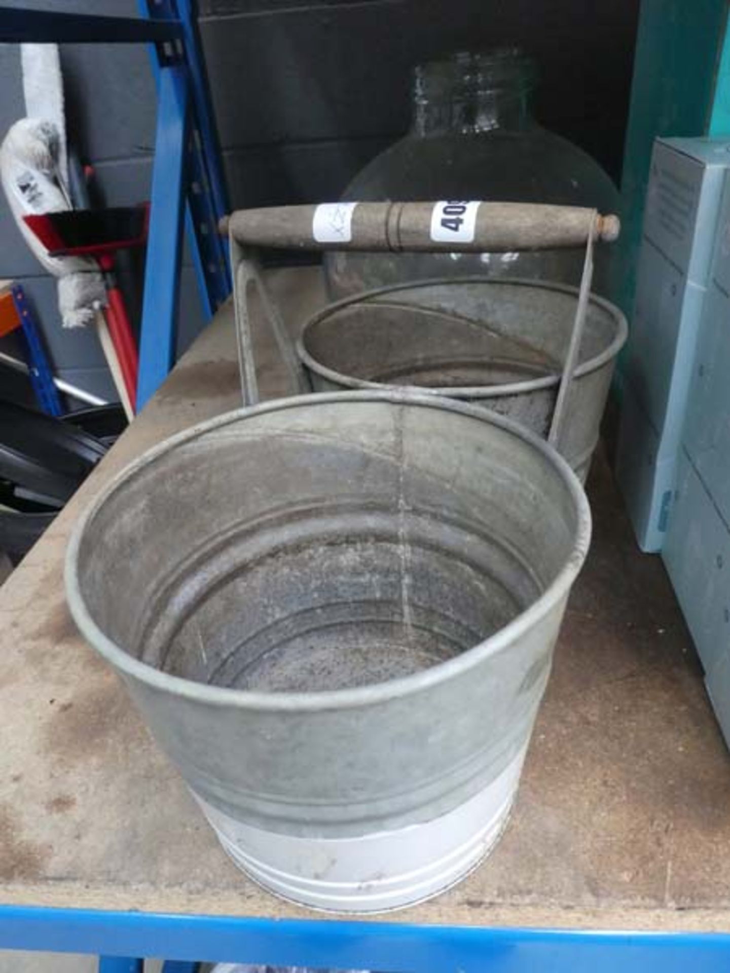 2 galvanized pots with a handle and a glass planter