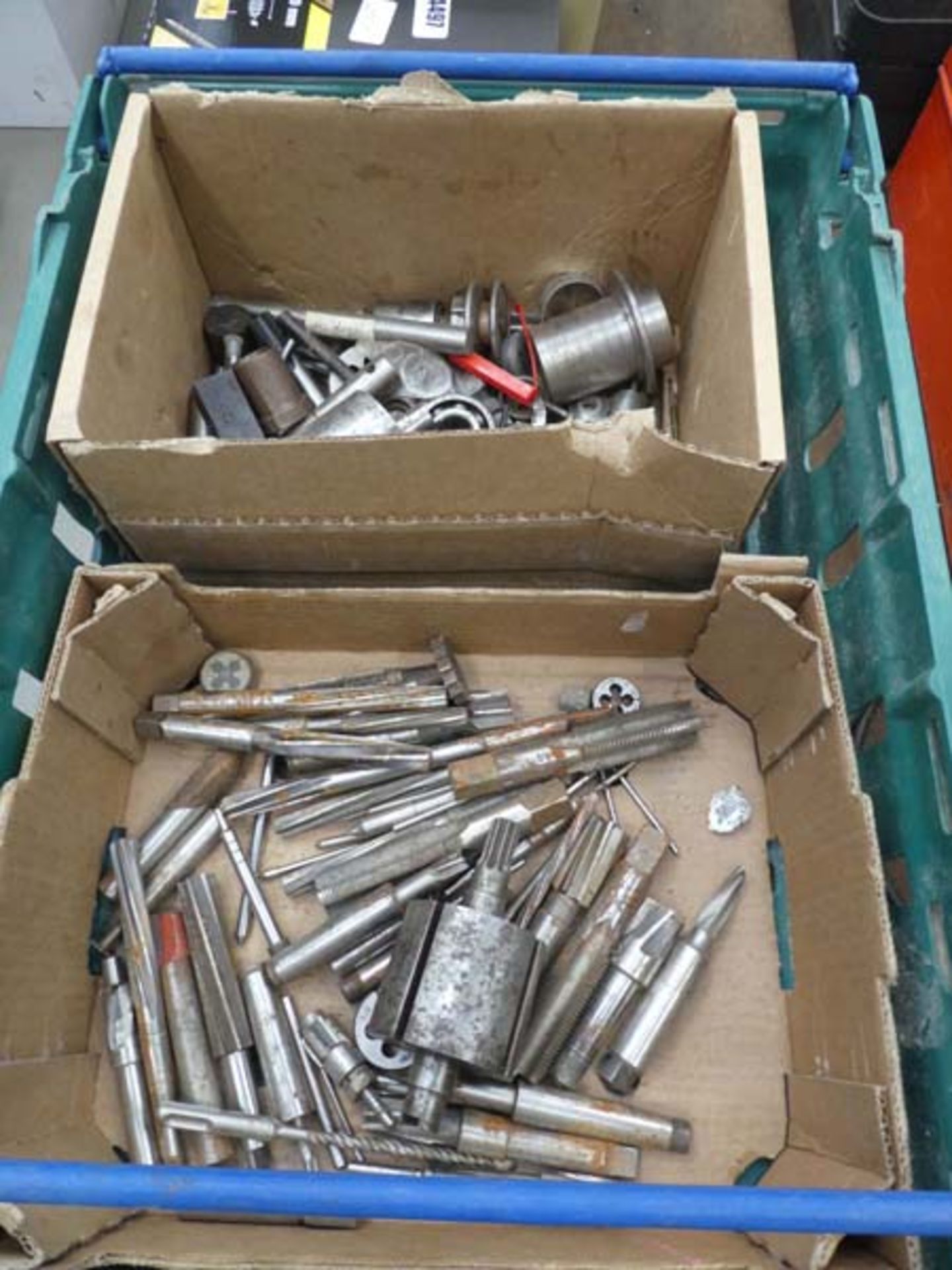 Plastic box of reamers, taps and other machine parts