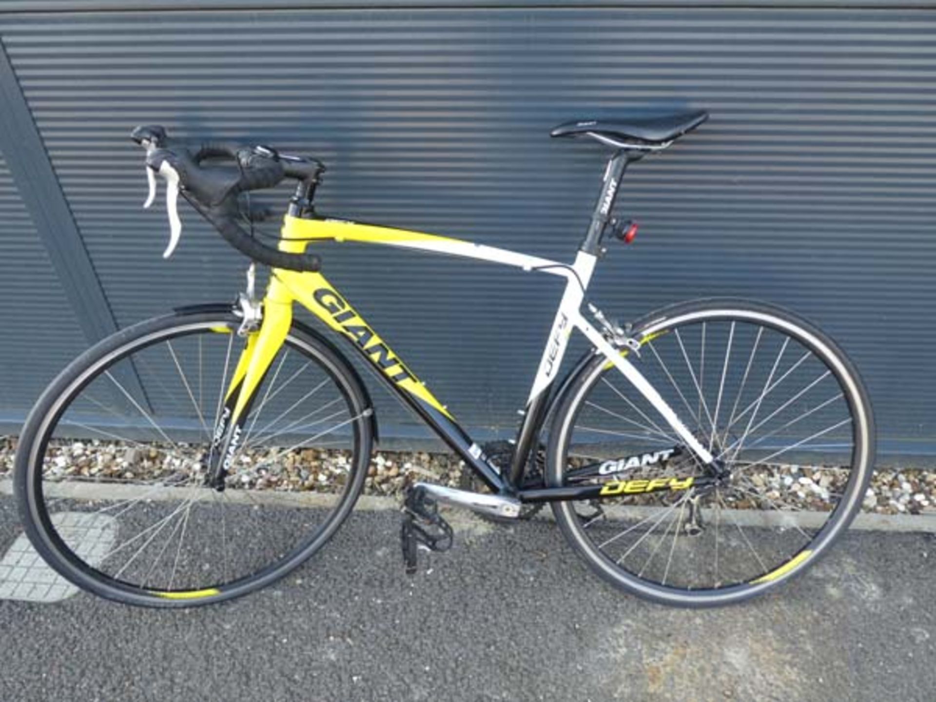 Yellow, black and white Giant Defy racing cycle