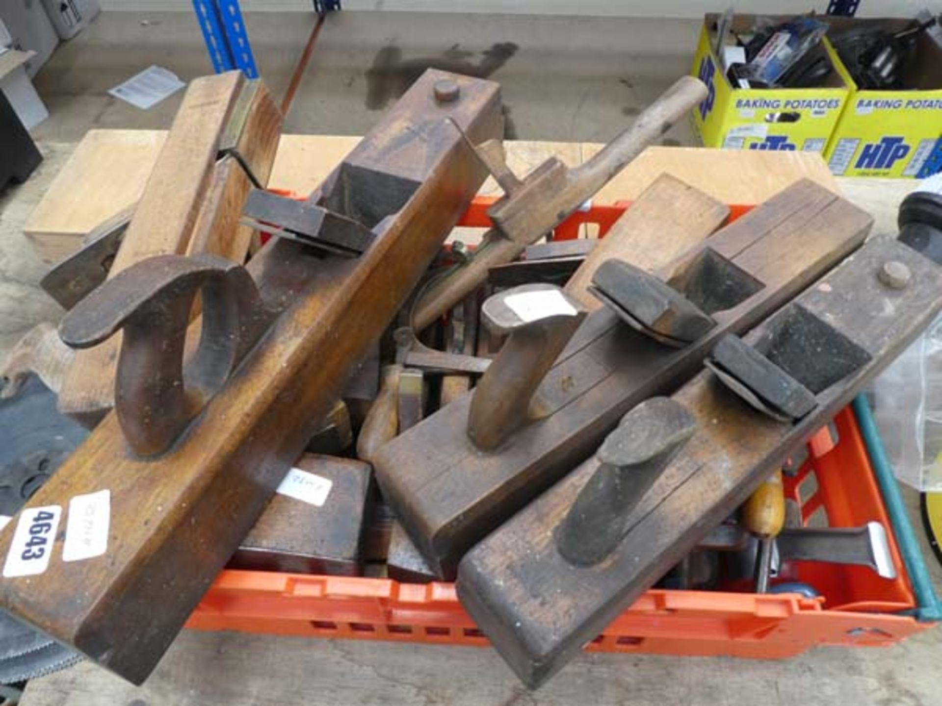 Large plastic basket with wooden planes and a wooden box of assorted tools