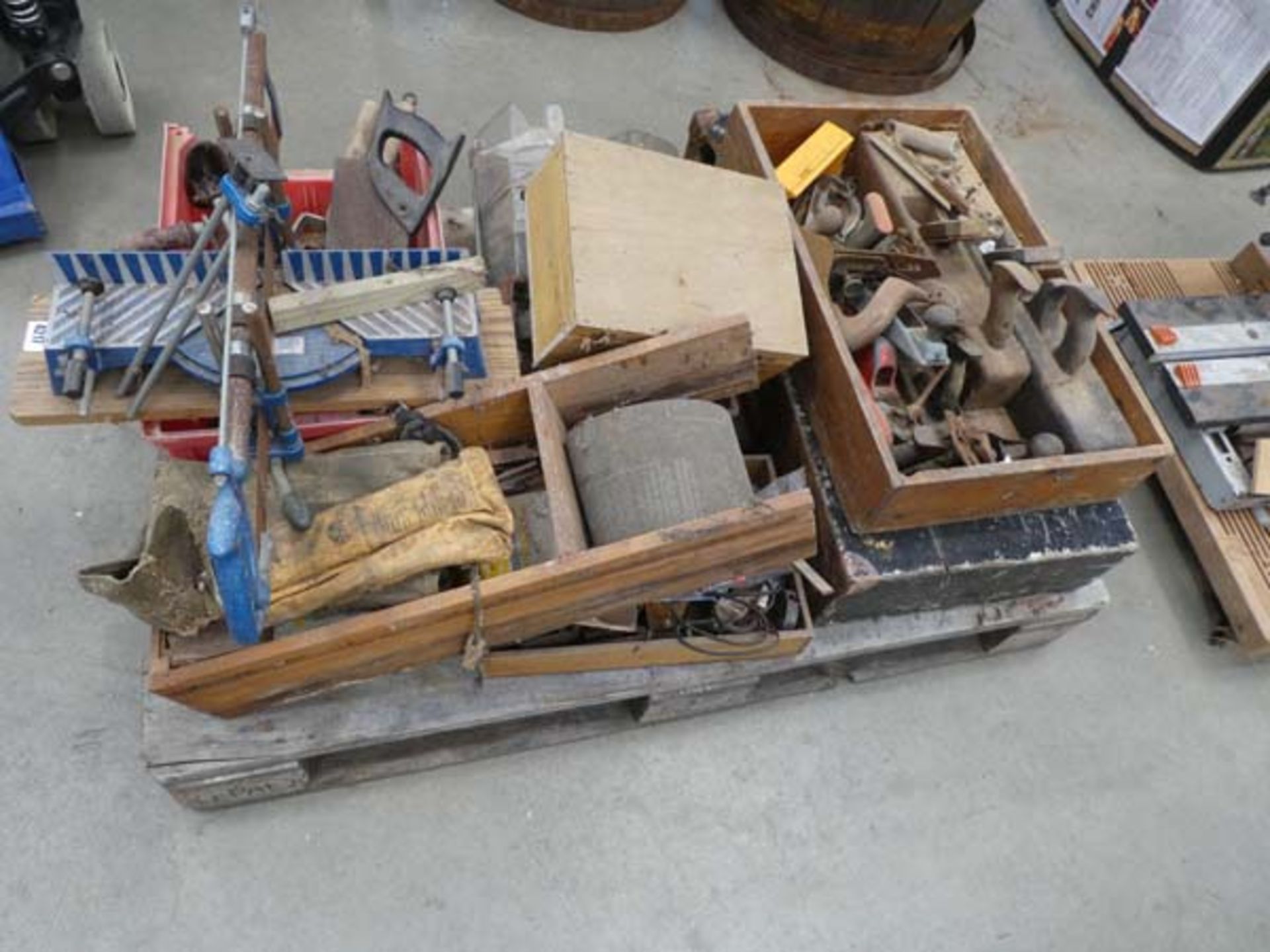 Pallet containing saws, hand planes, sandpaper, mitre saws, hand drills and various other tools