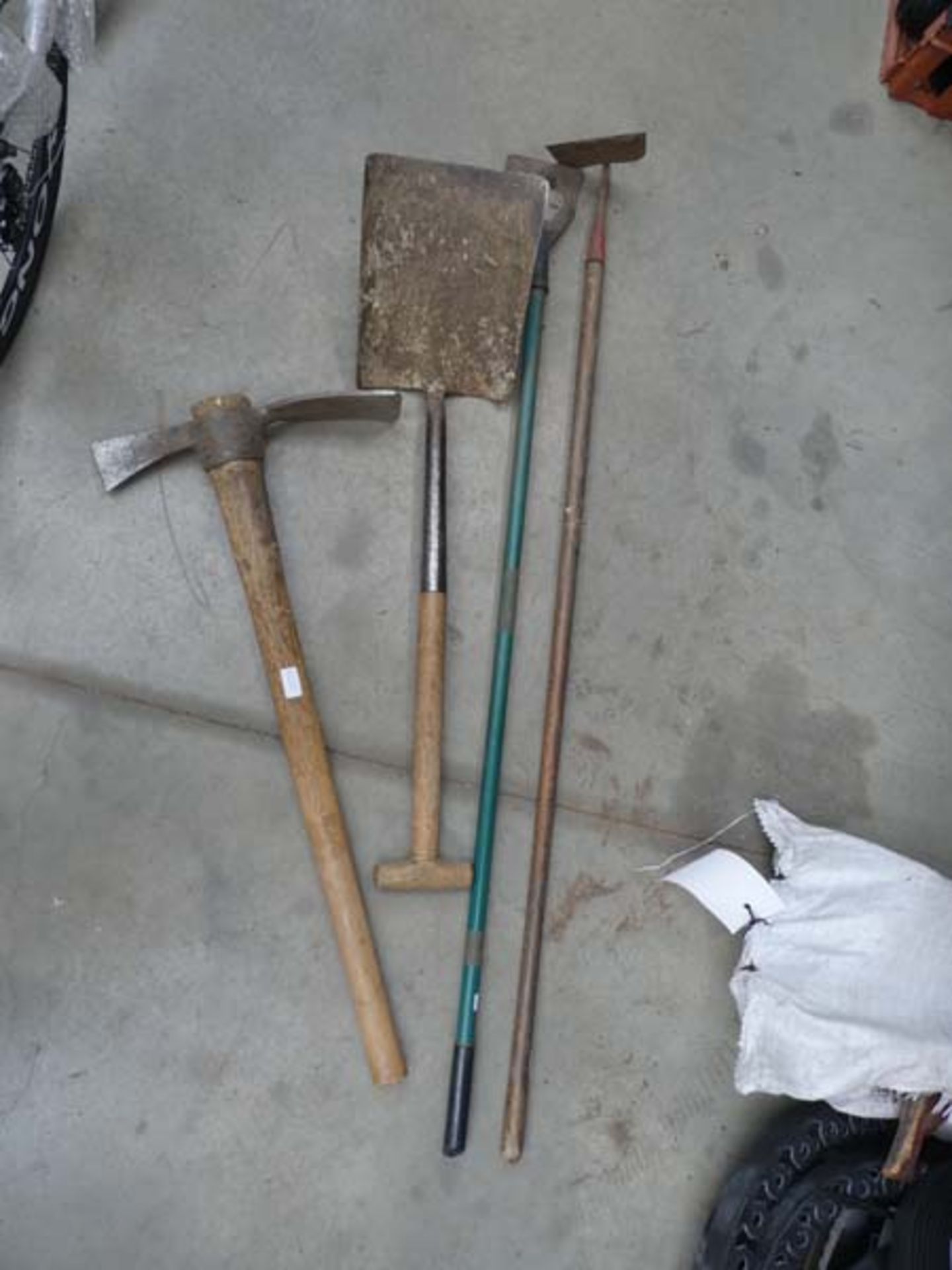 Small quantity of garden tool including pickaxe, shovel, hose, etc