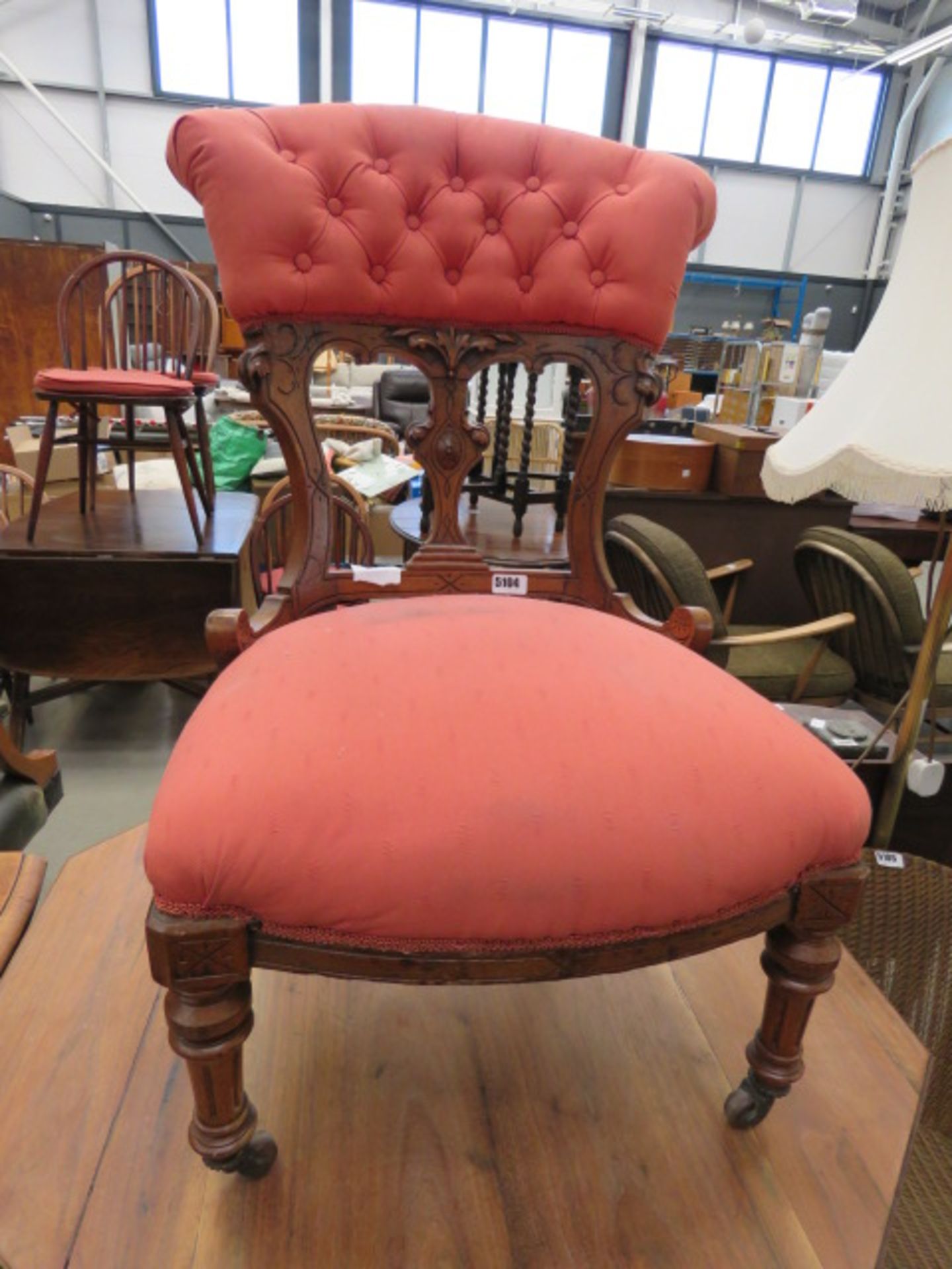 Carved Edwardian nursing chair in red fabric Back loose, seat slightly marked/stained