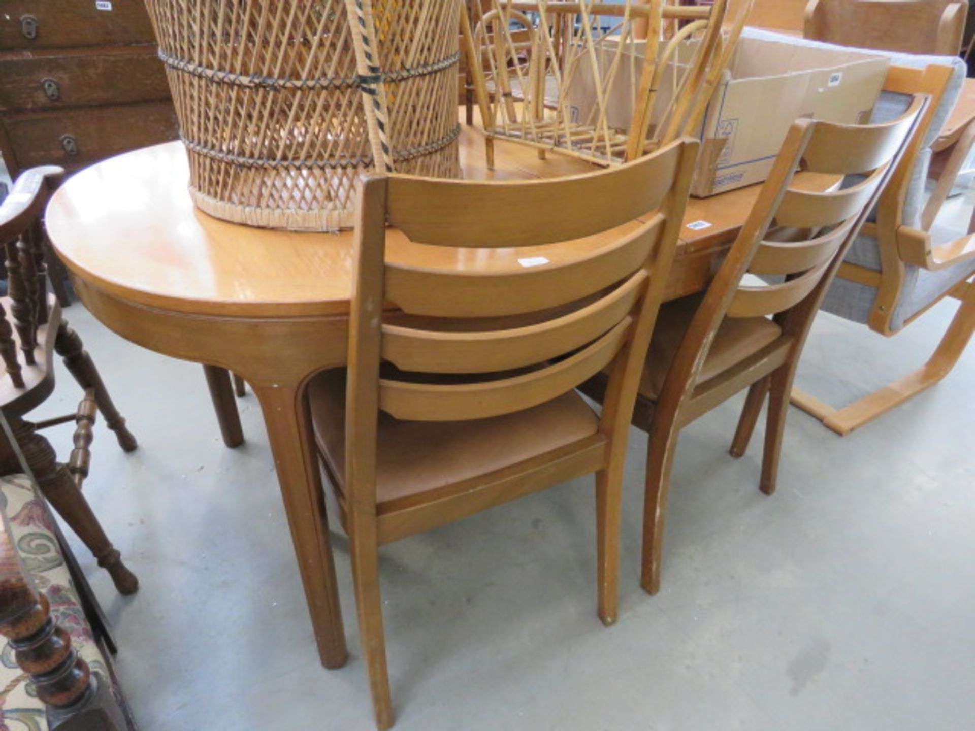 Oval teak extending dining table and 4 ladder back chairs Collector's item: see Soft Furnishings