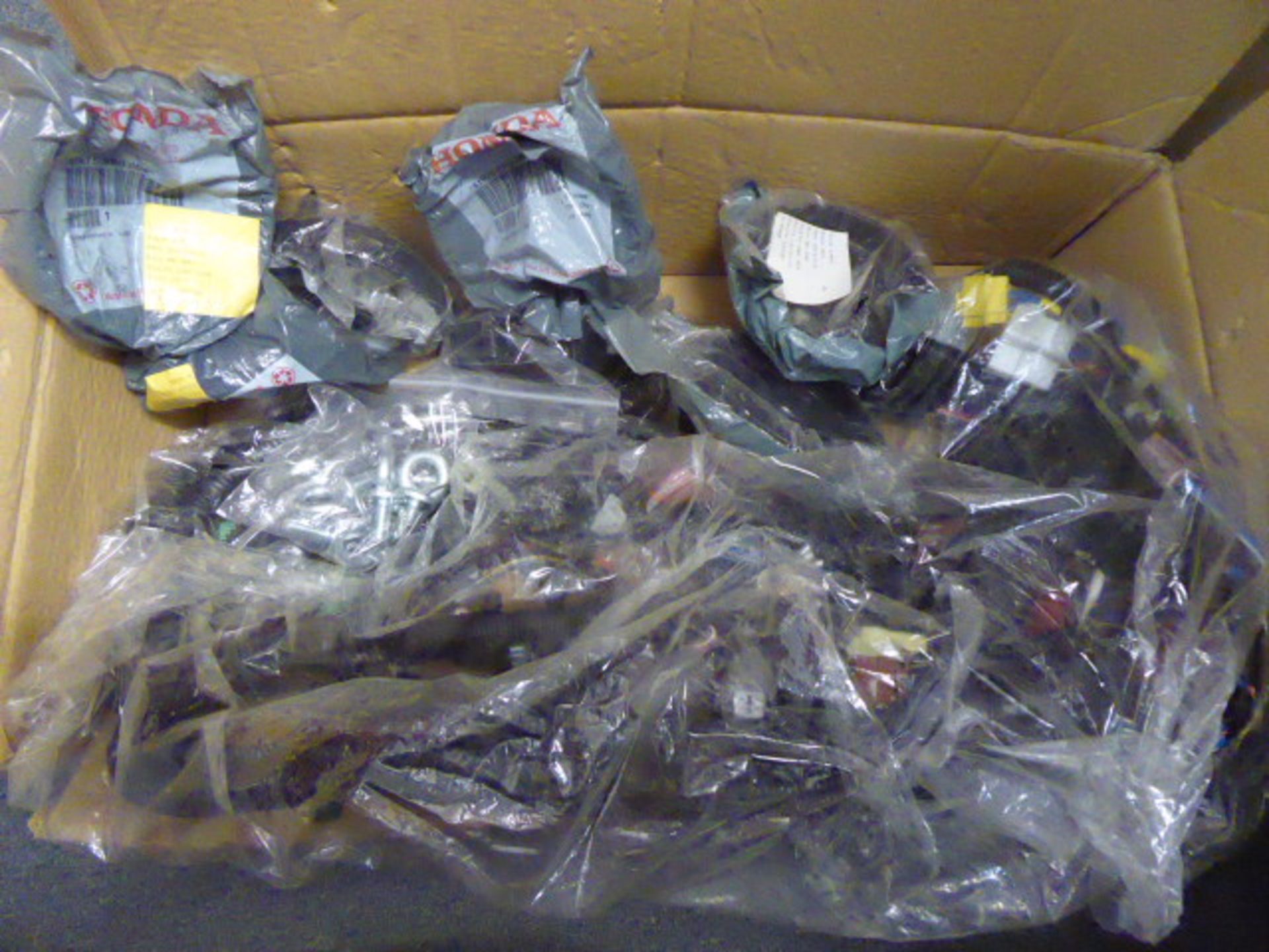 Box of assorted Honda genuine parts to include electrics and other