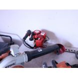 Red petrol engine hedge trimmer