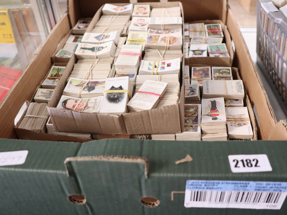 Box containing various themed cigarette cards incl. animals, trains, flowers, etc.