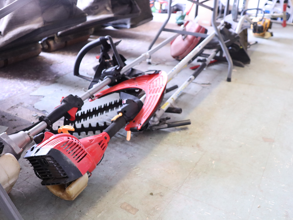 2 under bays of mixed petrol engine strimmers and brush cutters with various loose components