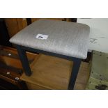 (12) Grey upholstered stool on dark grey supports