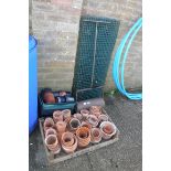 Garden roller, terracotta pots, plastic garden trays with pots and green metal shelving