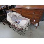 Childs ornamental pram with a doll