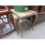 A nest of three metal and onyx nesting tables