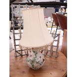 Ornate ceramic table lamp with beige shade