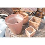 4 mixed size terracotta pots