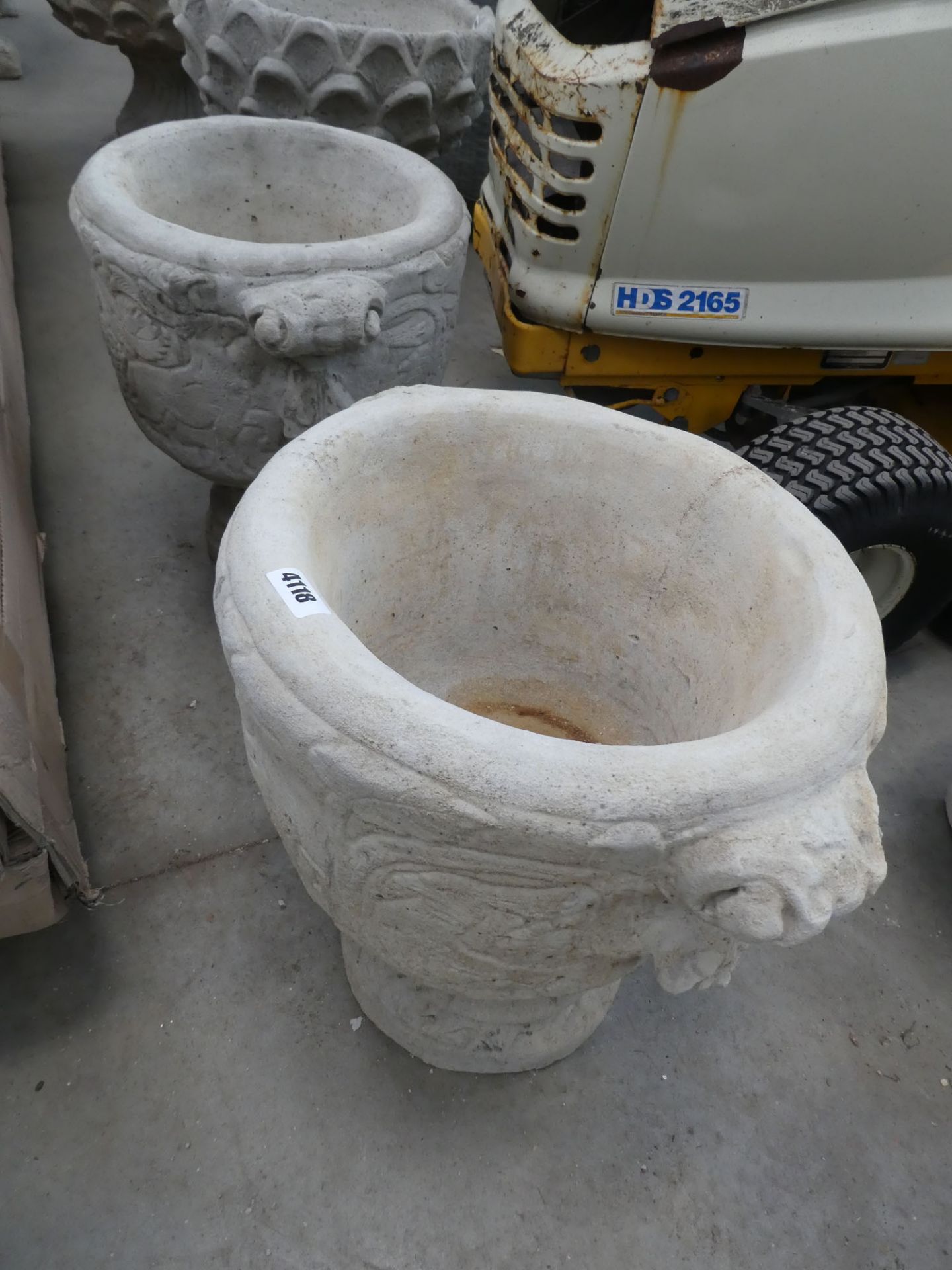 2 round concrete pots on stand