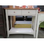 Cream painted oak finished table with two drawers and shelf under