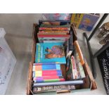 Box containing Harry Potter books and childrens' annuals