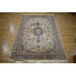 An Indian hand-woven wool carpet, the pale foliate ground with blue borders,
