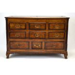 A Georgian oak and crossbanded mule chest, the lift lid over one long and three short drawers,