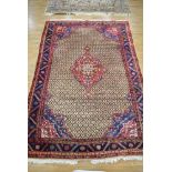 An Iranian hand-woven wool carpet, the red and blue detailed ground within matching borders,