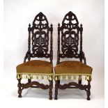 A pair of 17th century style carved oak hall/side chairs with high backs,