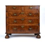 An early 18th century Queen Anne or George I walnut and feather banded chest of drawers,