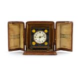 A cased Zenith Watch Co. miniature mantel timepiece in a champleve enamelled case with bun feet, h.