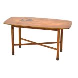 A 1960's walnut and marquetry occasional table of cushioned rectangular form decorated with a