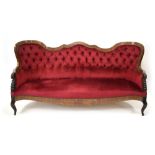 A 19th century rosewood and brass inlaid button upholstered rococo sofa on splayed legs with