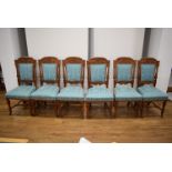 A set of six Victorian style mahogany dining chairs with foliate backs and floral seats