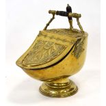 A Victorian brass coal scuttle with a fitted shovel,