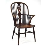 An 18th century wheelback Windsor armchair with an elm seat,